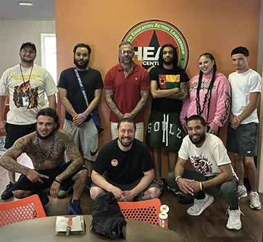 Team posing inside education center office