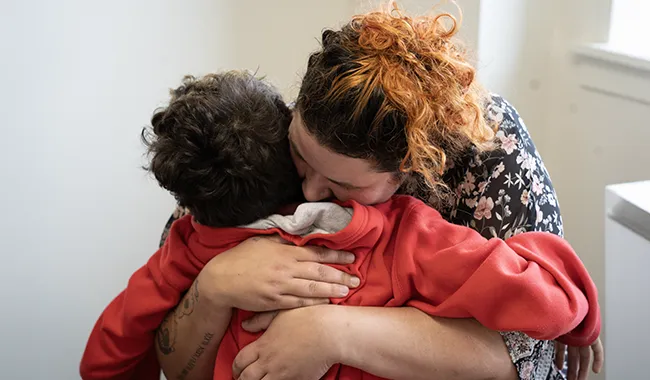 Mother hugging child in emotional moment